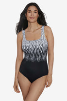 Woman wearing a black and white zig zag pattern on the bust one-piece swimsuit