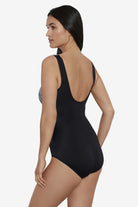 Woman turned left wearing a black and white zig zag pattern on the bust one-piece swimsuit