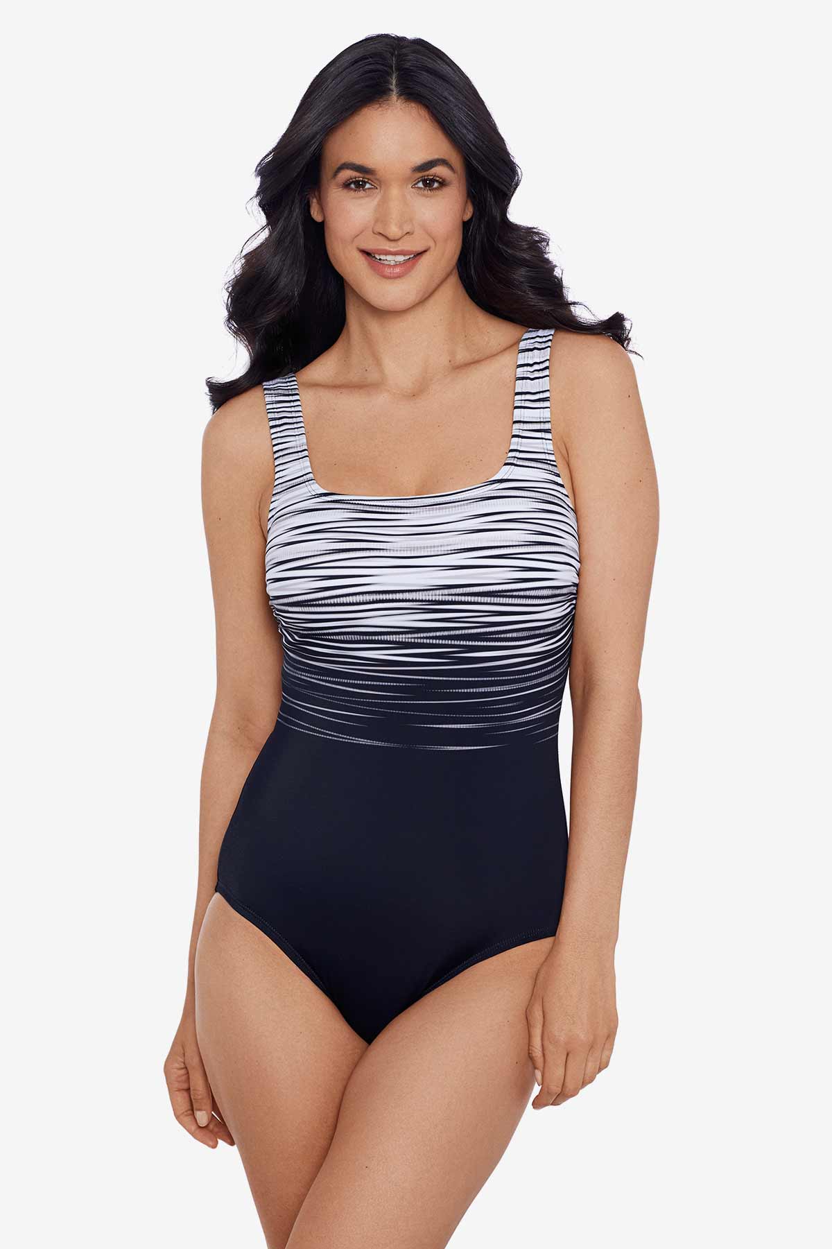 Woman wearing a black and white stripey pattern one-piece swimsuit