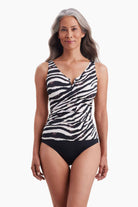 Woman wearing a zebra printed one-piece swimsuit with a sweetheart neckline