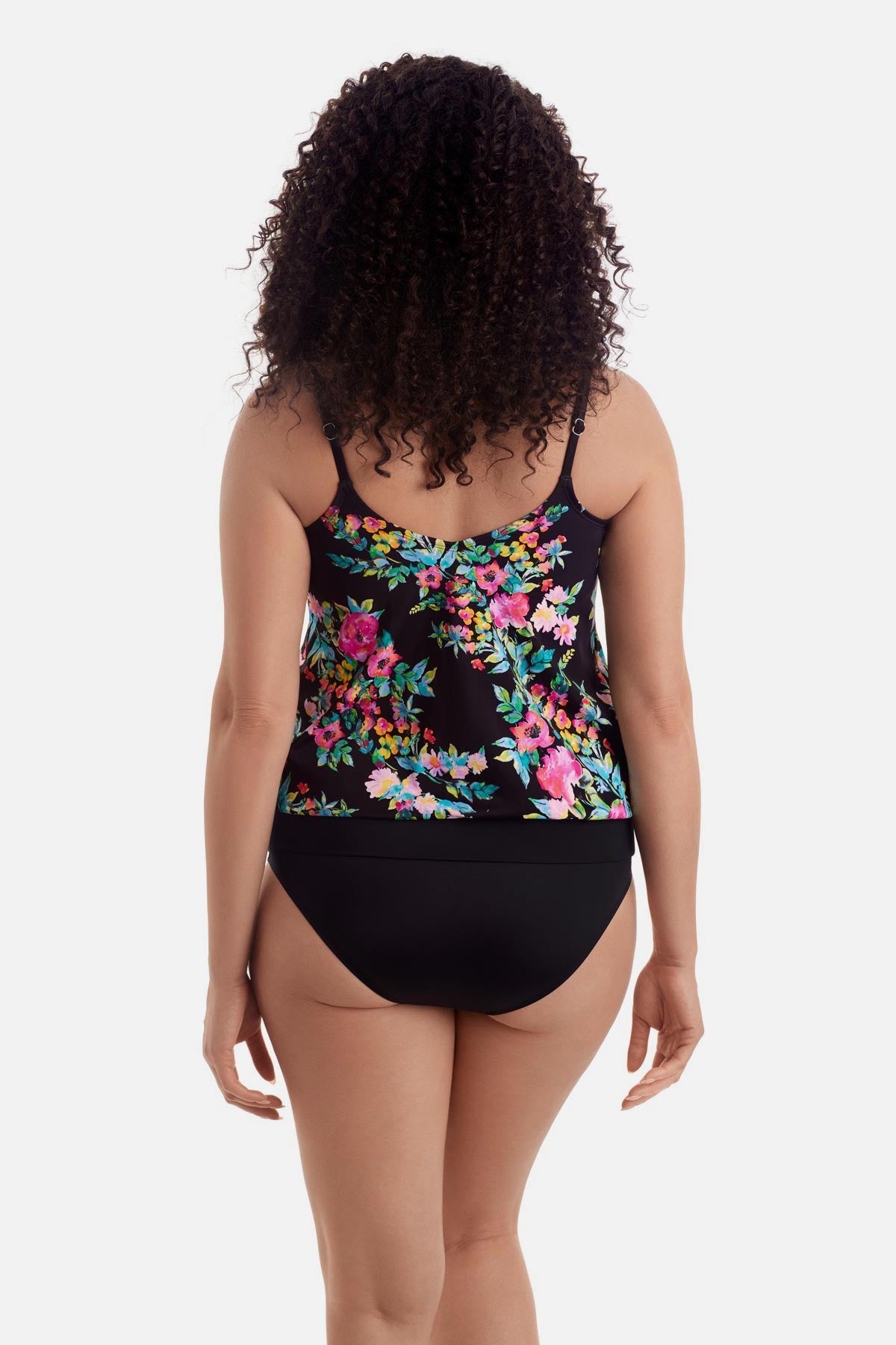Woman turned away wearing a multicolored floral printed blouson tankini top