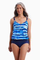 Woman wearing a blouson tankini top with a blue tie dye print