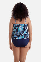 Woman turned away wearing a blue floral print shirred neck blouson tankini top