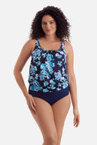 Woman wearing a blue floral print shirred neck blouson tankini top