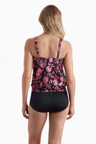 Woman faced away wearing a tankini top with a pink floral pattern