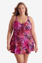 Woman wearing a pink palm leaf printed swim dress