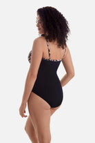 Woman turned left wearing a brown butterfly wing printed one-piece swimsuit 