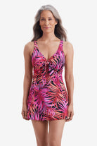 Woman wearing a pink palm leaf printed swim dress