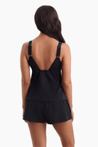 Woman facing away to show back detail of tankini top