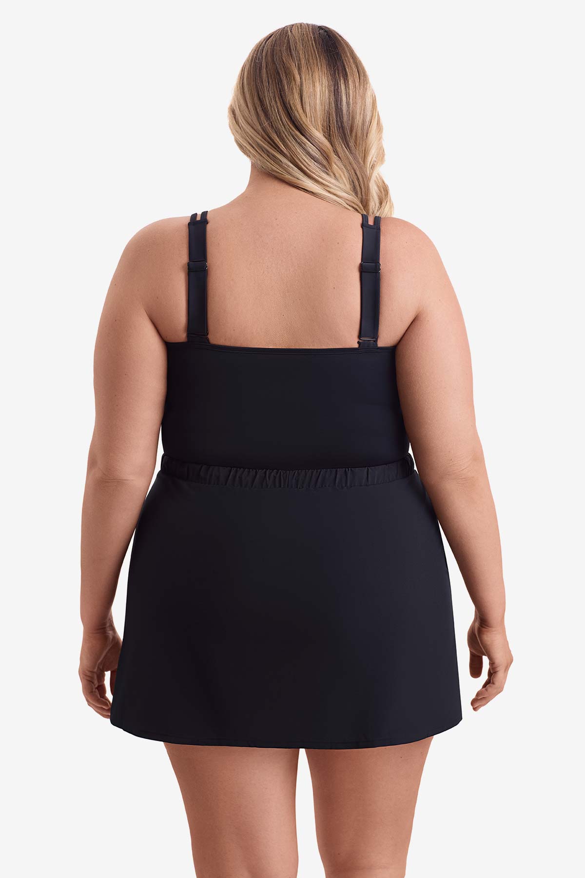 Woman faced away wearing a one-piece skirted swimsuit