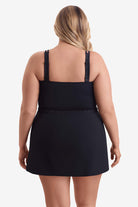 Woman faced away wearing a one-piece skirted swimsuit