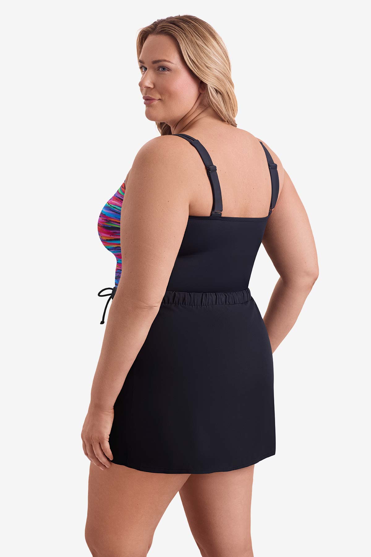 Woman turned left wearing a multicolored streaked print one-piece skirted swimsuit
