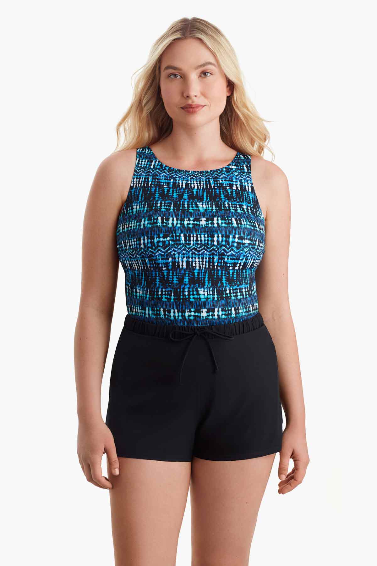Woman wearing a one-piece swimsuit with a blue print along the bust