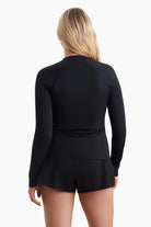 Woman facing away to show the detail on the back of the sun shirt
