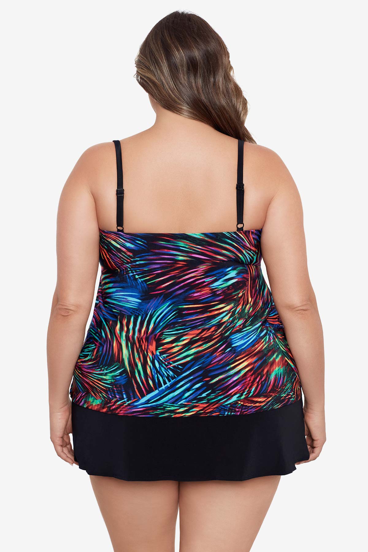 Woman turned away wearing a rainbow light burst pattern ruffle one-piece skirtini swimsuit