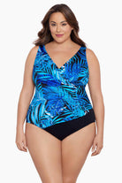 Woman wearing a blue palm leaf printed one-piece swimsuit