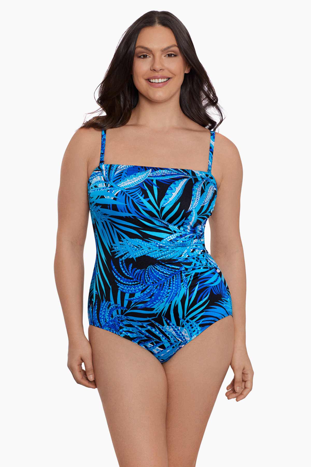 Woman wearing a blue palm leaf printed bandeau with straps one-piece swimsuit