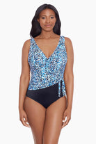 Woman wearing a blue dotted print ruffle neck one-piece swimsuit