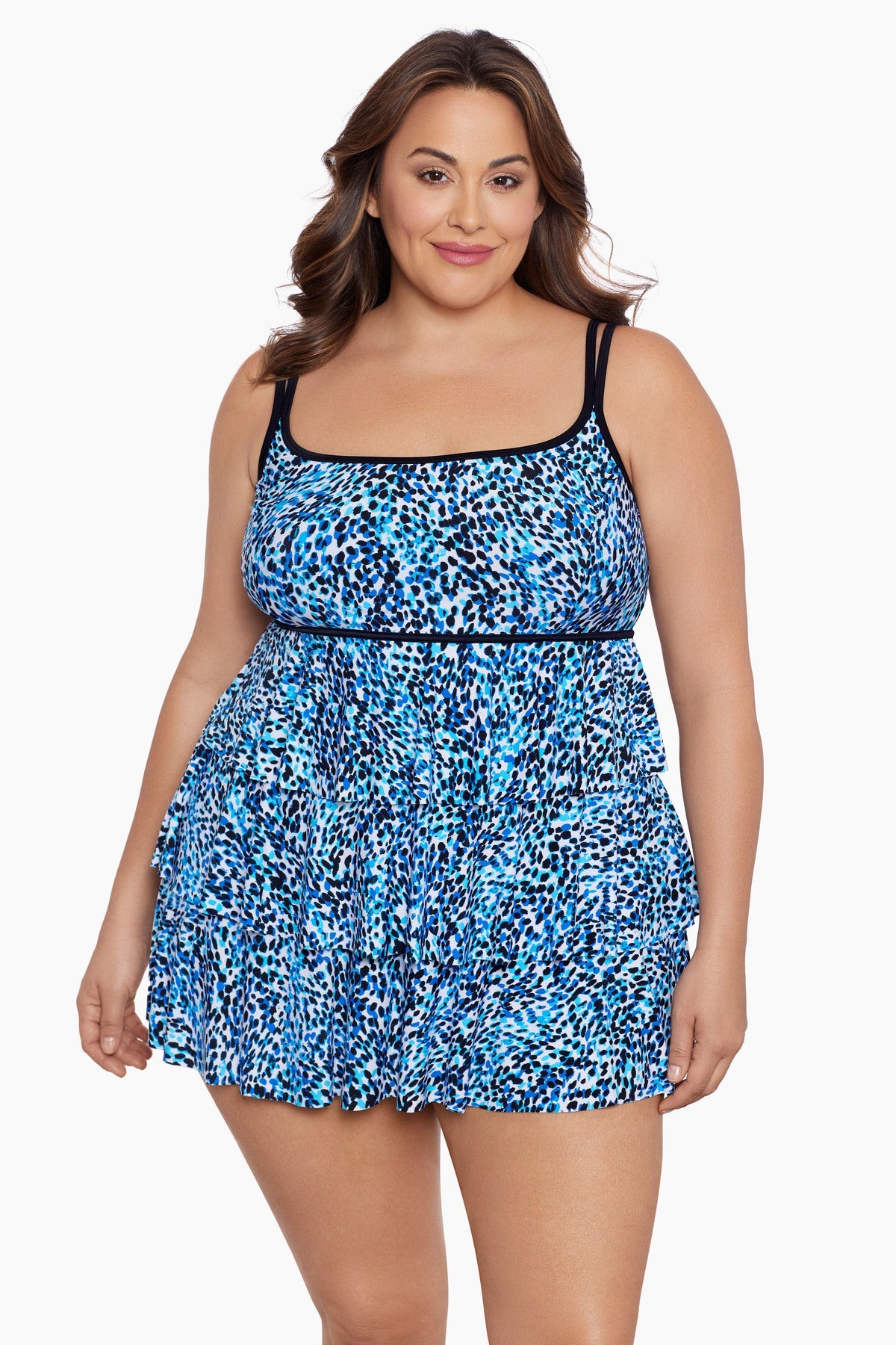 Woman wearing a multi-blue speckled swim dress with tiered ruffles