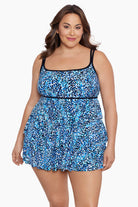 Woman wearing a multi-blue speckled swim dress with tiered ruffles