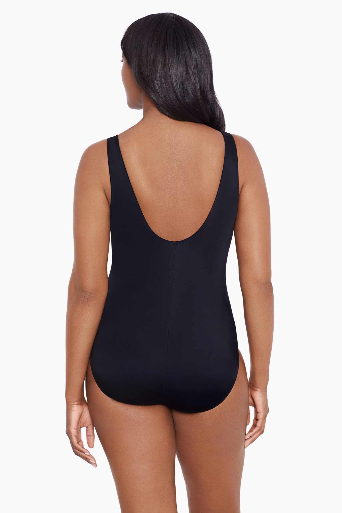 Woman faced away wearing a dotted print four streak one-piece swimsuit