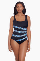Woman wearing a dotted print four streak one-piece swimsuit