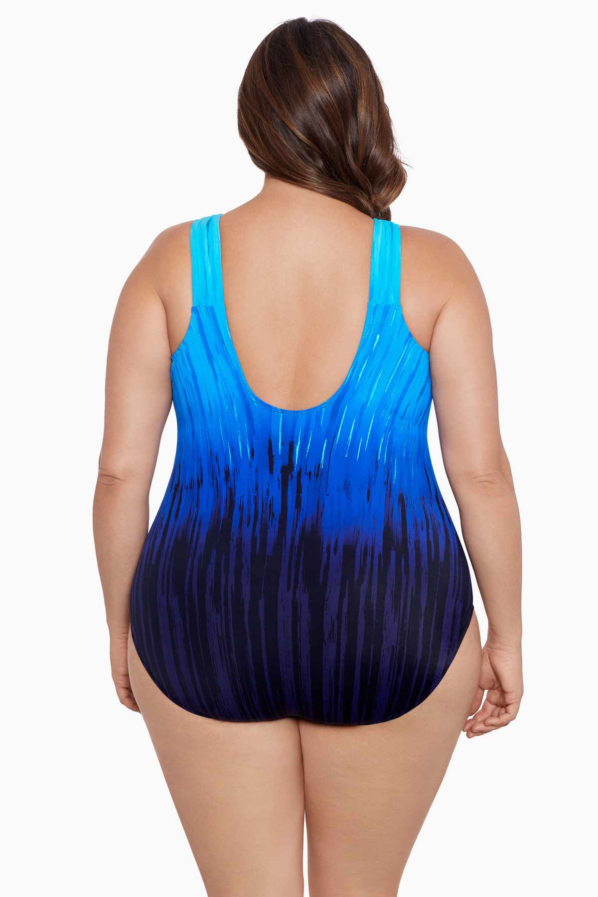 Woman turned away wearing a blue ombre streaked print one-piece swimsuit