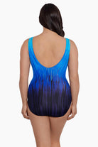 Woman turned away wearing a blue ombre streaky pattern one piece swimsuit