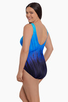 Woman turned left wearing a blue ombre streaky pattern one piece swimsuit