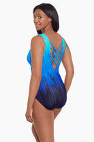 Woman turned left wearing a blue ombre streaky pattern one piece swimsuit