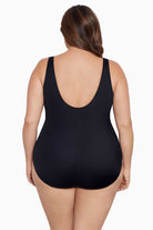 Woman faced away wearing a one-piece swimsuit