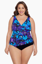 Woman wearing a blue and gold floral printed one-piece swimsuit