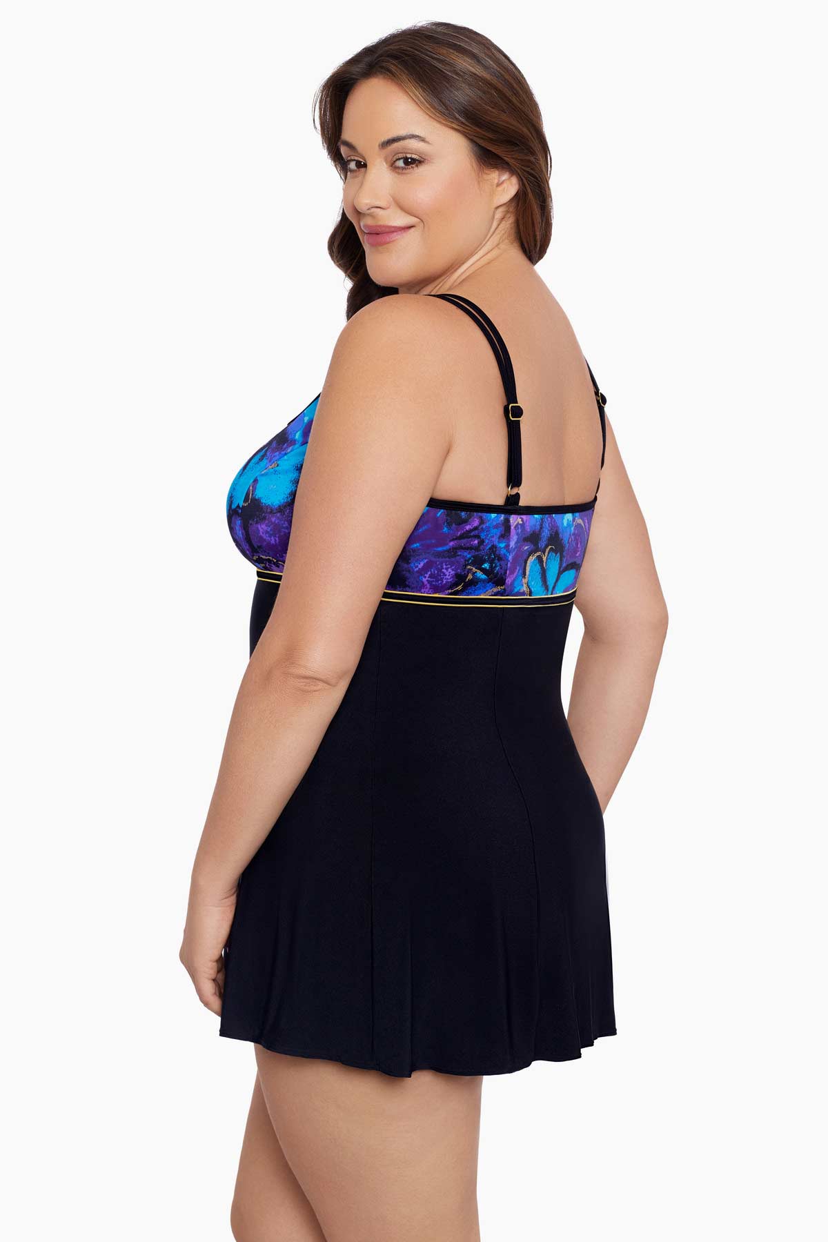 Woman faced left wearing a blue and gold floral printed at the bust black swim dress