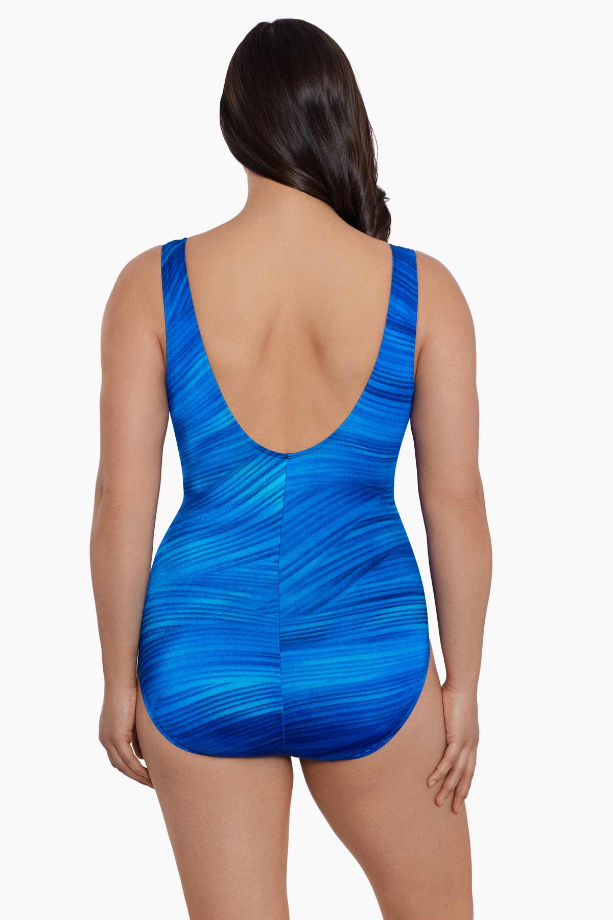 Woman faced away wearing a blue streaked pattern one-piece swimsuit