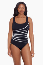 Woman wearing a black and white streaked fan pattern one-piece swimsuit
