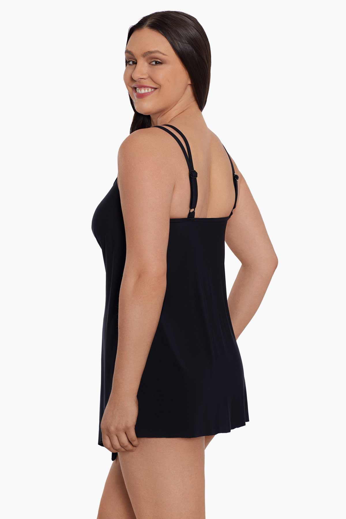 Woman faced left wearing a black drapey swim dress