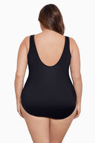 Woman faced away wearing a black mesh high neck one-piece swimsuit