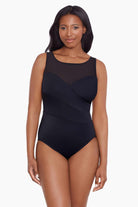 Woman wearing a black mesh high neck one-piece swimsuit