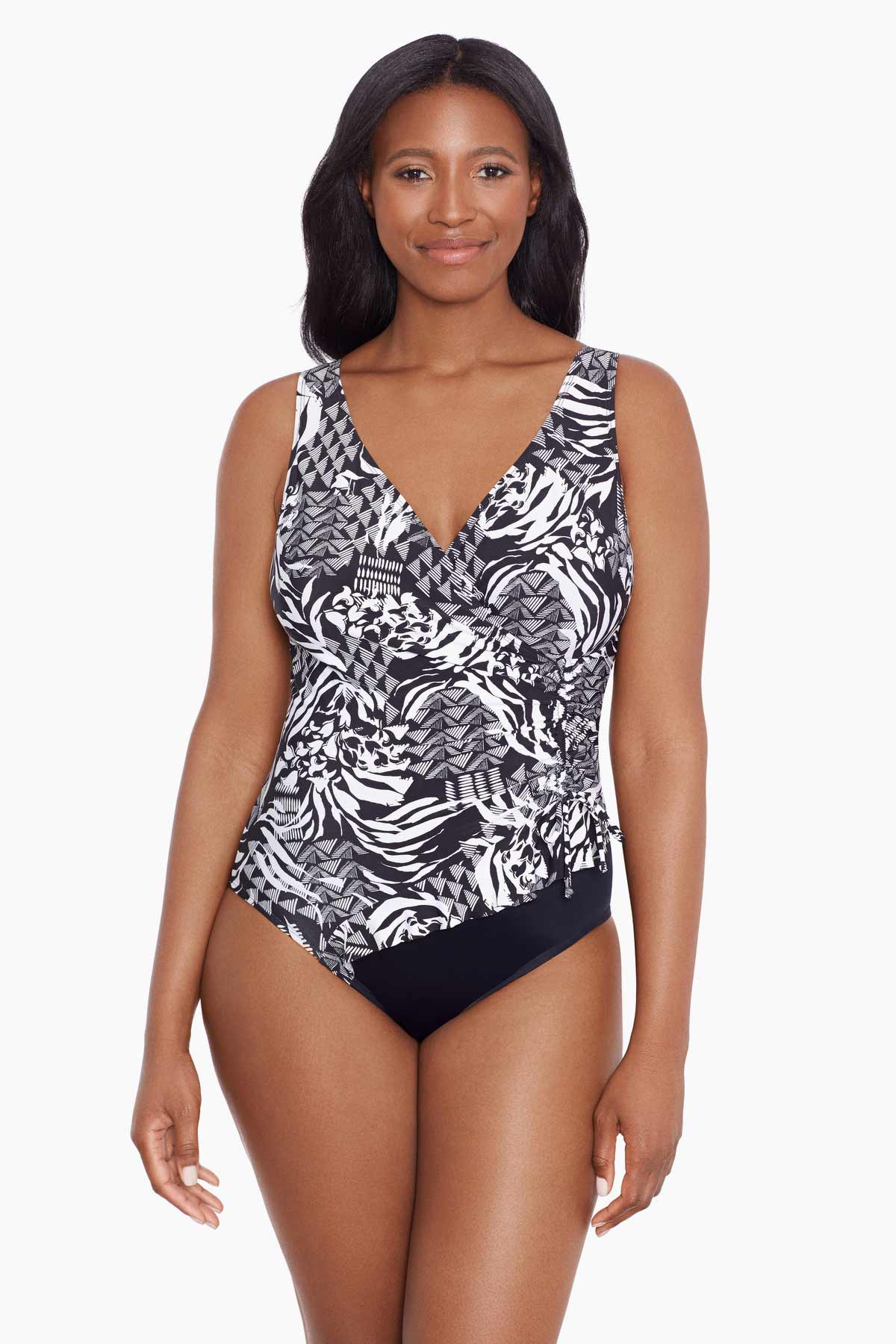 Woman wearing a black and white abstract printed one-piece swimsuit