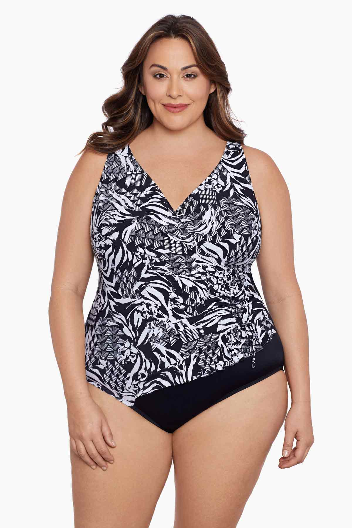 Woman wearing a black and white geometric pattern one-piece swimsuit