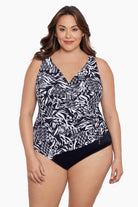 Woman wearing a black and white geometric pattern one-piece swimsuit