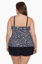 Woman faced away wearing a black and white abstract printed ruffle shortini
