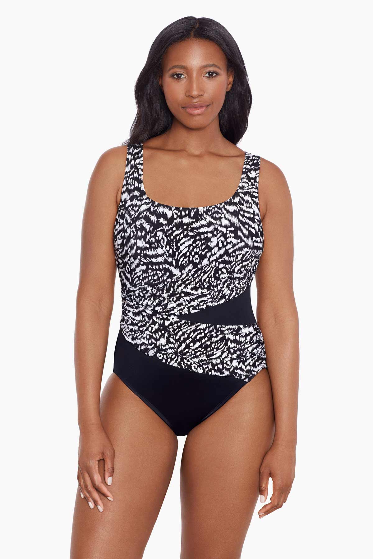 Woman wearing a black and white abstract printed one-piece swimsuit with mesh cutout on the side