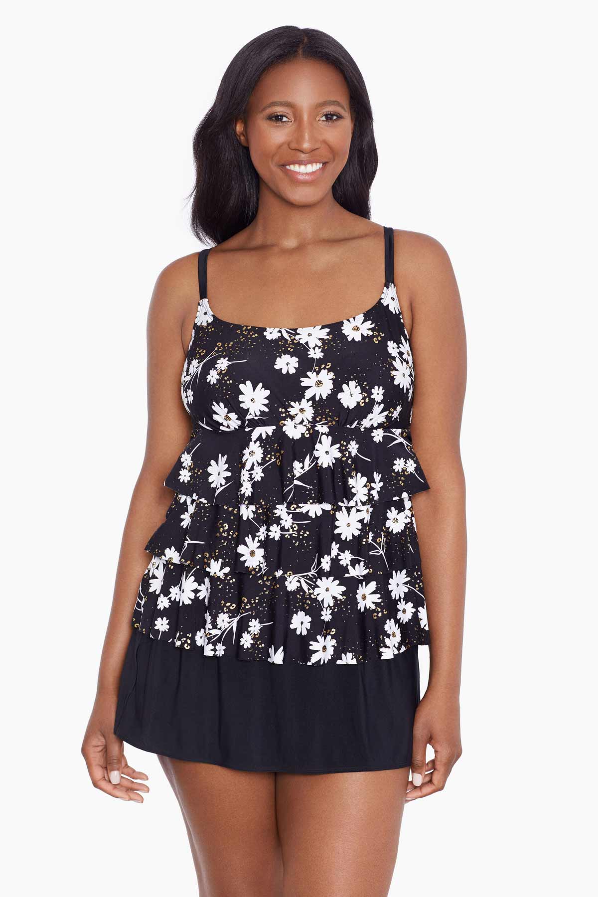 Woman wearing a black and white floral ruffled skirtini swimsuit