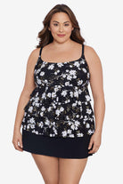 Woman wearing a small white flower printed black skirtini swimsuit with ruffles