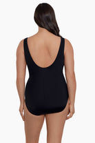 Woman faced away wearing a one-piece swimsuit