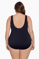 Woman faced away wearing a  black blocked one-piece swimsuit