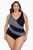 Woman wearing a black and white black blocked one-piece swimsuit
