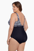 Woman turned left wearing a black and white garland printed one-piece high neck swimsuit
