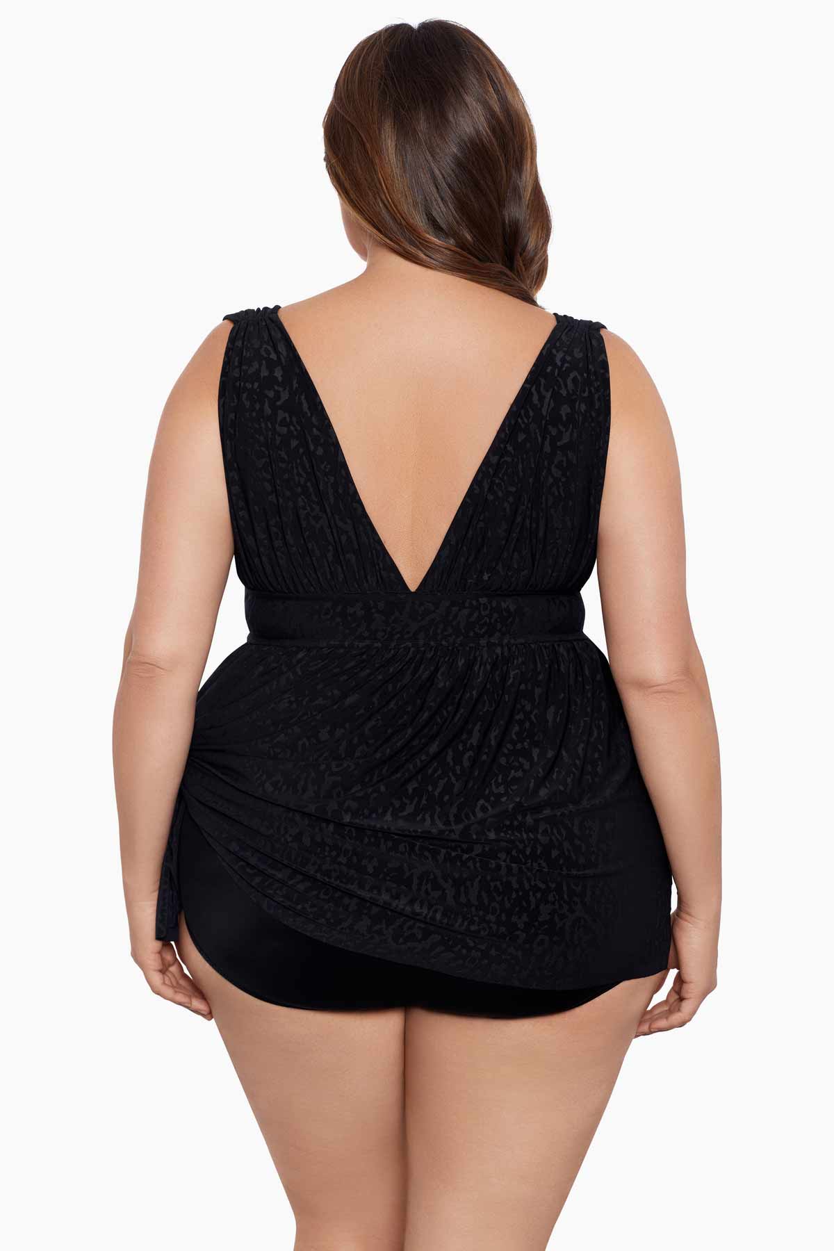 Woman faced away wearing a black light animal-esque printed swim dress
